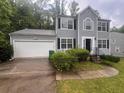 Charming two-story home with a well-maintained lawn, attached garage, and inviting front entrance at 5769 Shadow Creek Dr, Lithonia, GA 30058