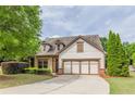 Charming home featuring a two-car garage, manicured lawn, and inviting craftsman architecture at 1355 Hesse Ln, Austell, GA 30106