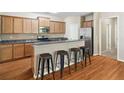 Open kitchen featuring a breakfast bar with seating, granite countertops, and stainless steel appliances at 1355 Hesse Ln, Austell, GA 30106