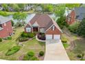 Charming brick home with a well-maintained front lawn, mature landscaping, and attached two-car garage at 3390 Mill Valley Dr, Dacula, GA 30019