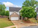 Inviting two-story home with brick facade, lush front lawn, and a cozy porch with rocking chairs at 461 Timberleaf Rd, Canton, GA 30115