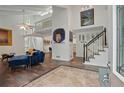 Open-concept living room with a modern staircase, vaulted ceiling, and hardwood floors at 495 Ramsdale Dr, Roswell, GA 30075