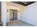 A covered patio with a white brick wall and a black framed sliding glass door at 51 Deer Canyon Dr, Auburn, GA 30011