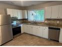Well-lit kitchen featuring stainless steel appliances and ample counter space at 1685 Pheasant Dr, Jonesboro, GA 30238