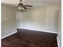 Spacious living room boasting hardwood floors, light gray walls, and a ceiling fan at 1685 Pheasant Dr, Jonesboro, GA 30238