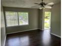 Bright living room featuring hardwood floors, ceiling fan, and view to outdoor space at 1685 Pheasant Dr, Jonesboro, GA 30238