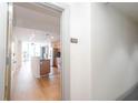 Condo hallway view to unit 815 leading into a kitchen with wood floors and stainless appliances at 3040 Peachtree Nw Rd # 815, Atlanta, GA 30305