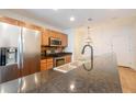 Granite countertops highlight this kitchen with stainless steel appliances and stylish wooden cabinets at 3040 Peachtree Nw Rd # 815, Atlanta, GA 30305