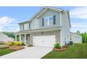 Two-story home featuring a combination of brick and siding, along with a neat lawn and a convenient two-car garage at 3135 Ellenton Dr, Lithia Springs, GA 30122