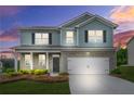Inviting two-story home with brick and siding, showcasing a manicured lawn and an attached two-car garage for convenience at 3135 Ellenton Dr, Lithia Springs, GA 30122
