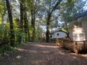A spacious backyard with trees and a deck in a serene and wooded setting at 3948 Valley Brook Rd, Snellville, GA 30039