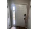 An entryway door features a side window for natural light, enhancing its appeal at 3948 Valley Brook Rd, Snellville, GA 30039