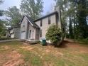 The exterior features include a siding and a lush, tree-filled surrounding landscape at 3948 Valley Brook Rd, Snellville, GA 30039