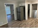 Kitchen featuring stainless steel refrigerator and views of stairs and living area at 1263 Shoreham Dr, Atlanta, GA 30349