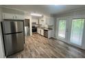 Kitchen featuring stainless steel appliances, white cabinets, and wood flooring at 1263 Shoreham Dr, Atlanta, GA 30349