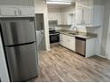 Well-lit kitchen with stainless steel appliances, gray cabinets and modern countertops at 1263 Shoreham Dr, Atlanta, GA 30349