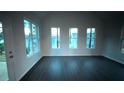 Bright living room with dark floors and multiple large windows at 210 Park Place Trl, Social Circle, GA 30025