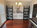 Elegant dining room showcasing hardwood floors, stylish shelving, and a piano at 2122 Riverbirch Ct, Lawrenceville, GA 30044