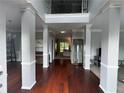 Grand foyer featuring soaring ceilings, hardwood floors, and decorative columns at 2122 Riverbirch Ct, Lawrenceville, GA 30044