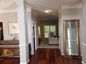 Inviting foyer with hardwood floors, decorative columns, and ample natural light at 2122 Riverbirch Ne Ct, Lawrenceville, GA 30044