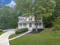 Beautiful two-story home with a charming front porch and a neatly landscaped yard with a walkway at 405 Sable Trace Cv, Acworth, GA 30102