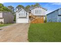 Two-story home featuring light gray siding, front yard, garage and a wood deck at 4811 Nevilly Way, Marietta, GA 30066