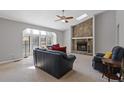 Living room featuring a stone fireplace, carpeted floor and lots of natural light at 4811 Nevilly Way, Marietta, GA 30066