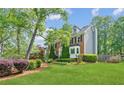 Beautiful home with lush landscaping, green lawn, and classic architectural details at 22 Oakwood Hills Dr, Suwanee, GA 30024