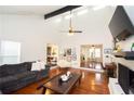 Sun-filled living room boasts high ceilings, hardwood floors, modern furniture, and seamless flow to dining area at 3404 Vinings North Se Trl, Smyrna, GA 30080