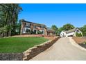 Beautiful brick home featuring a long driveway and well-manicured lawn at 180 Spring Ridge Trace, Roswell, GA 30076
