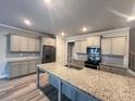 Well-equipped kitchen with a large island, granite countertops, and stainless steel appliances at 2458 Morgan Creek Rd, Buford, GA 30519