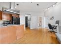 Open-concept living area featuring hardwood floors, recessed lighting, and an efficient kitchen at 2626 Peachtree Nw Rd # 606, Atlanta, GA 30305