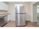 Kitchen view showing a stainless steel refrigerator with granite countertops and wood-look flooring at 3497 Glensford Dr, Decatur, GA 30032