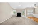 Bright and airy living room with fireplace, ceiling fan, and access to a deck at 1452 Evanston Ln, Marietta, GA 30062