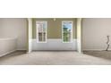 Bright living room features chair rail, large windows, and neutral color palette at 1452 Evanston Ln, Marietta, GA 30062