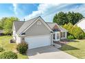 Lovely single-Gathering home with attached garage, trimmed lawn, and attractive architectural details at 2602 Midler Ct, Buford, GA 30519