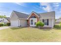 Lovely single-story home with a two-car garage, bay window, and green lawn, perfect for a Gathering at 2602 Midler Ct, Buford, GA 30519