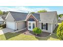 Traditional single-story home with landscaped front yard, bay window, and two-car garage, offering great curb appeal at 2602 Midler Ct, Buford, GA 30519