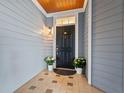 Charming front door with blue siding, tiled entryway, and potted plants at 4100 Paces Se Walk # 4306, Atlanta, GA 30339