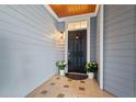 Charming front door with sidelight, accent plants, and decorative tile flooring at 4100 Paces Se Walk # 4306, Atlanta, GA 30339