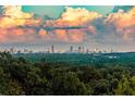 A gorgeous view of the city skyline is set against a backdrop of orange-tinted clouds at sunset at 4100 Paces Se Walk # 4306, Atlanta, GA 30339