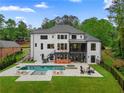 Spacious backyard featuring a pool, outdoor seating, and multi-level deck, perfect for entertaining at 575 Indian Hills Pkwy, Marietta, GA 30068