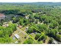 Wide aerial shot highlighting the property lines, structures, and lush landscape at 5855 Willis Ln, Cumming, GA 30040