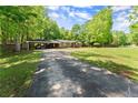 Long driveway leading to a cozy home with a convenient carport and ample parking space at 5855 Willis Ln, Cumming, GA 30040