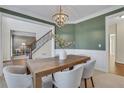 Inviting dining room with elegant chandelier and plenty of natural light at 1215 Wynridge Xing, Alpharetta, GA 30005