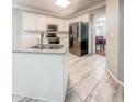 Well-lit kitchen featuring an island sink, granite countertops, stainless steel appliances, and sleek white cabinets at 1485 Oglethorpe Run Ln, Suwanee, GA 30024