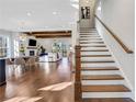 Bright and airy living room with a staircase, fireplace, wood floors, and an open floor plan at 160 Cricket Ln, Alpharetta, GA 30009