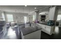 Open kitchen features a center island, modern appliances, granite countertops, and a breakfast area at 118 Reunion Pl, Acworth, GA 30102