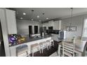 Bright kitchen boasts granite countertops, stainless appliances, and an adjacent dining area at 118 Reunion Pl, Acworth, GA 30102