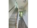 Bright hallway with stairs, wood floors, and modern decor at 283 Wells Cir, Canton, GA 30114